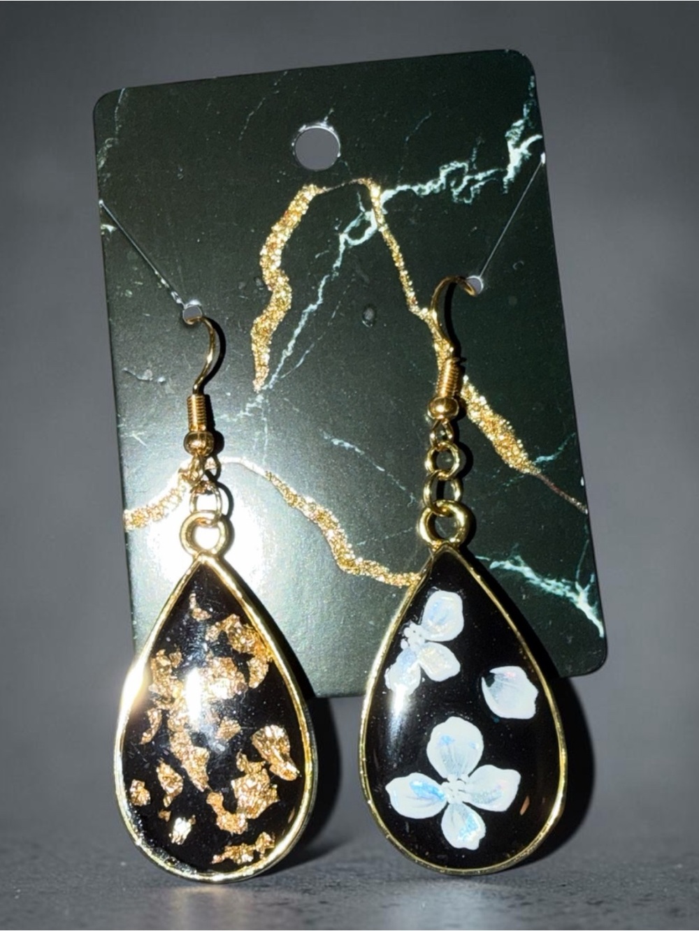 Asymmetric Black Teardrop Earrings with Gold Trim and Floral Accent